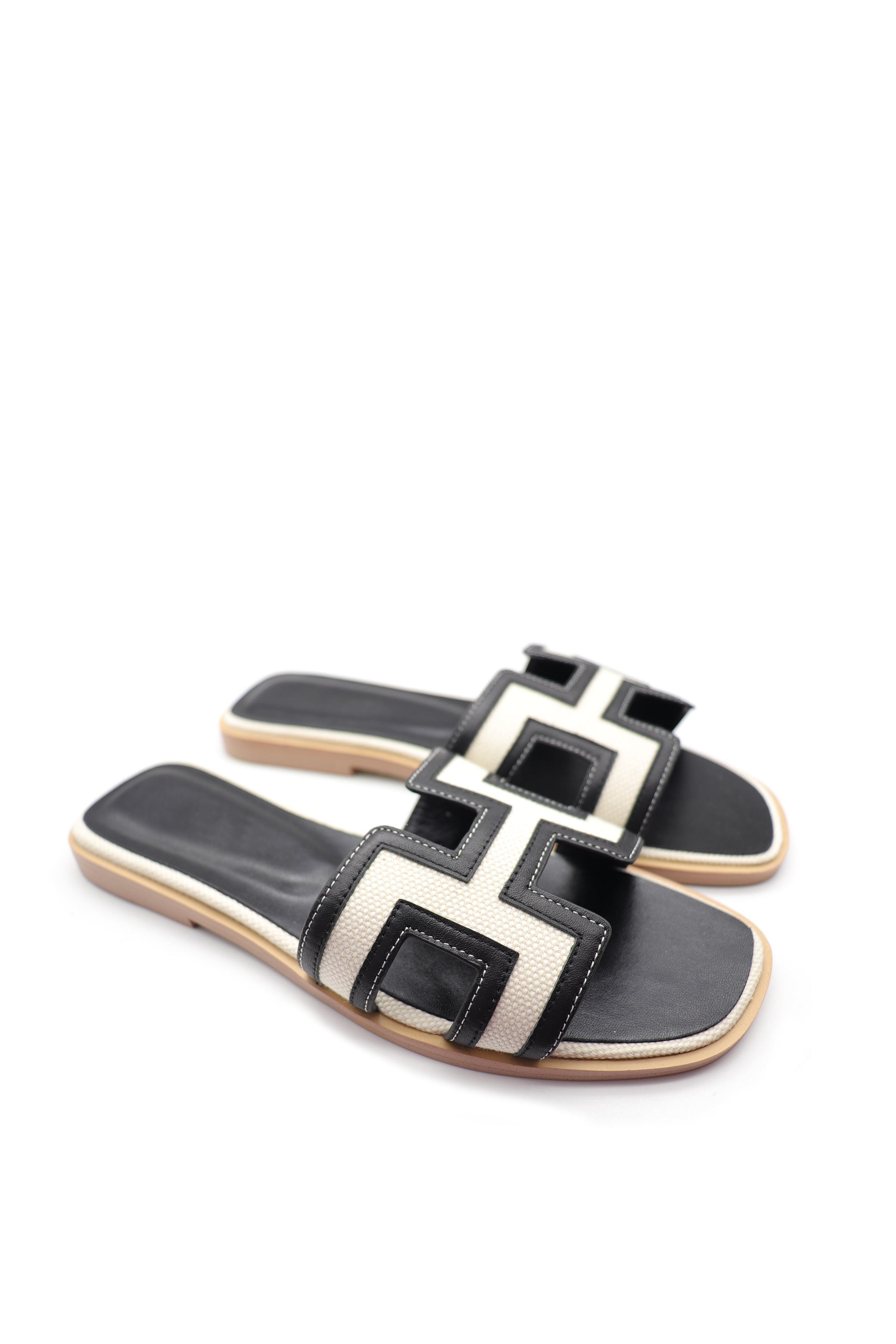 Black and white cowhide and canvas leather slippers