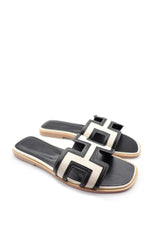 Black and white cowhide and canvas leather slippers